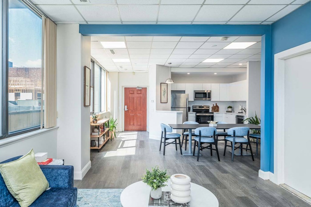 a living room and kitchen with a table and chairs